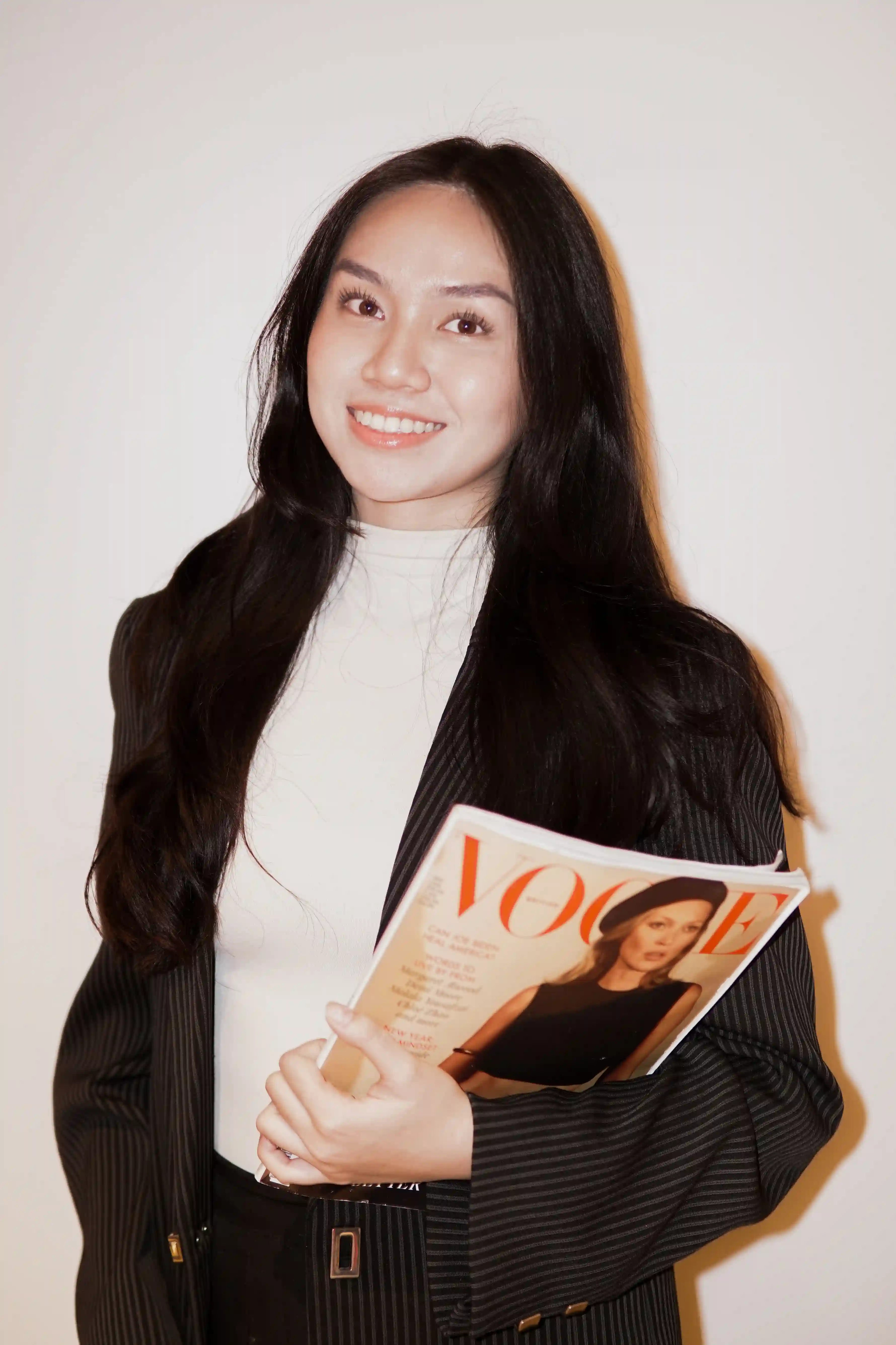 KATA team member on a phone call while holding the mock magazine spread, alternate angle